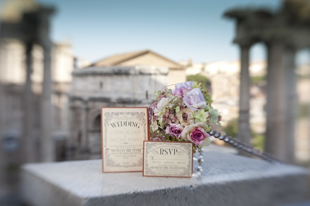 wedding invitation in front of roman ruins