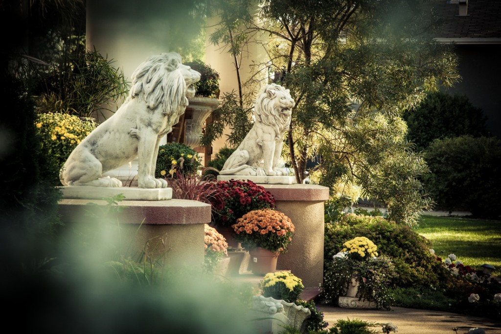 Lion statues in front of mansion