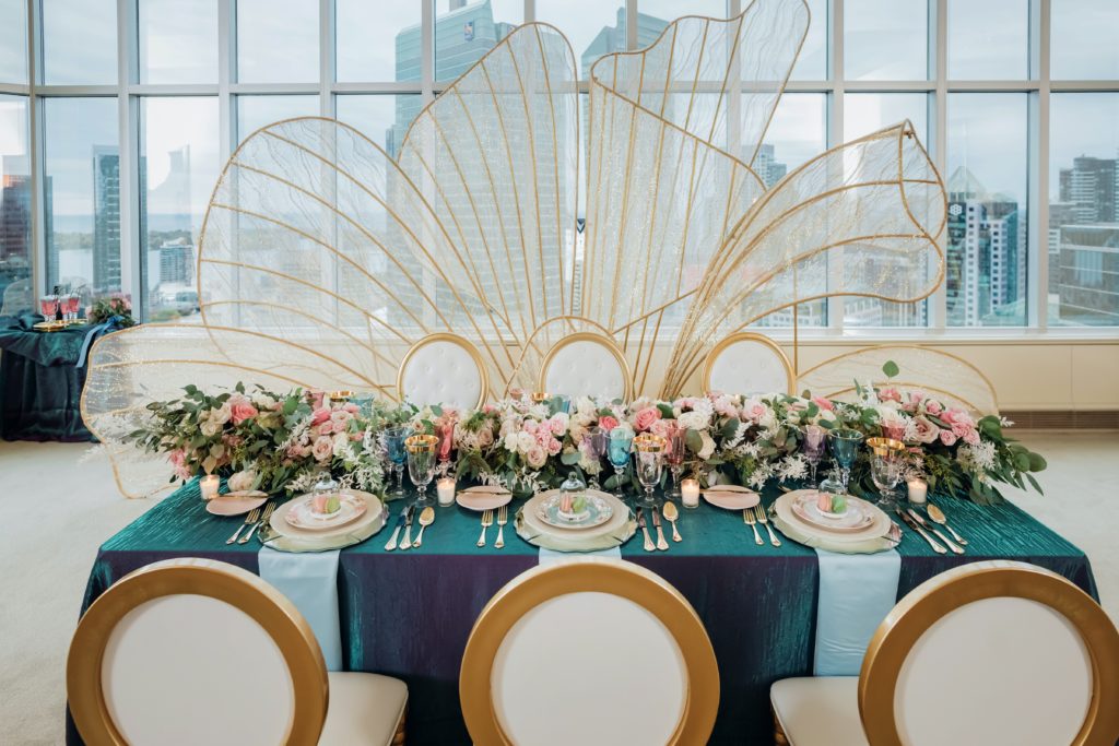Whimsical luxury wedding reception setup overlooking Toronto skyline.