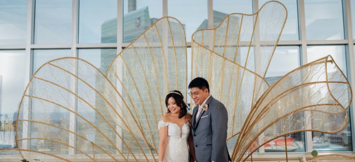 bride and groom standing in front of cn tower, luxury wedding