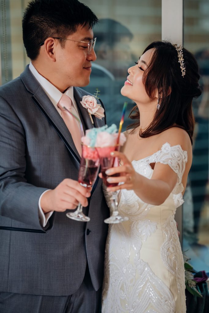 Bride and Groom cheers with cotton candy cocktails