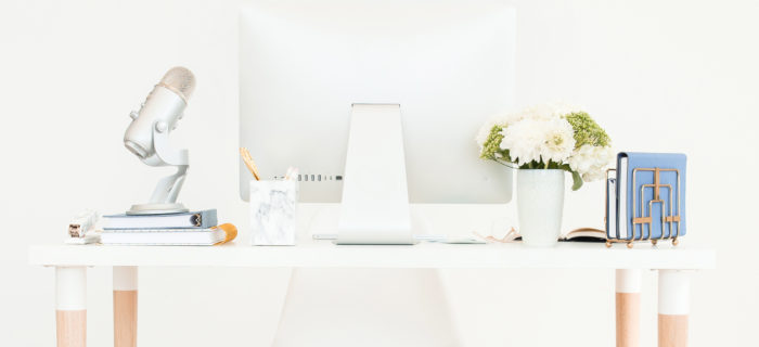 A feminine computer and desk of a blogger.