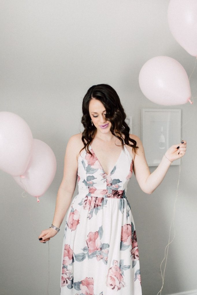 A wedding planner holding balloons