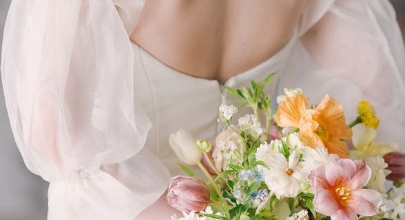 bride holding bouquet behind back