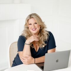 Danielle Andrews, expert wedding planner and President of WPIC, sitting at her desk.