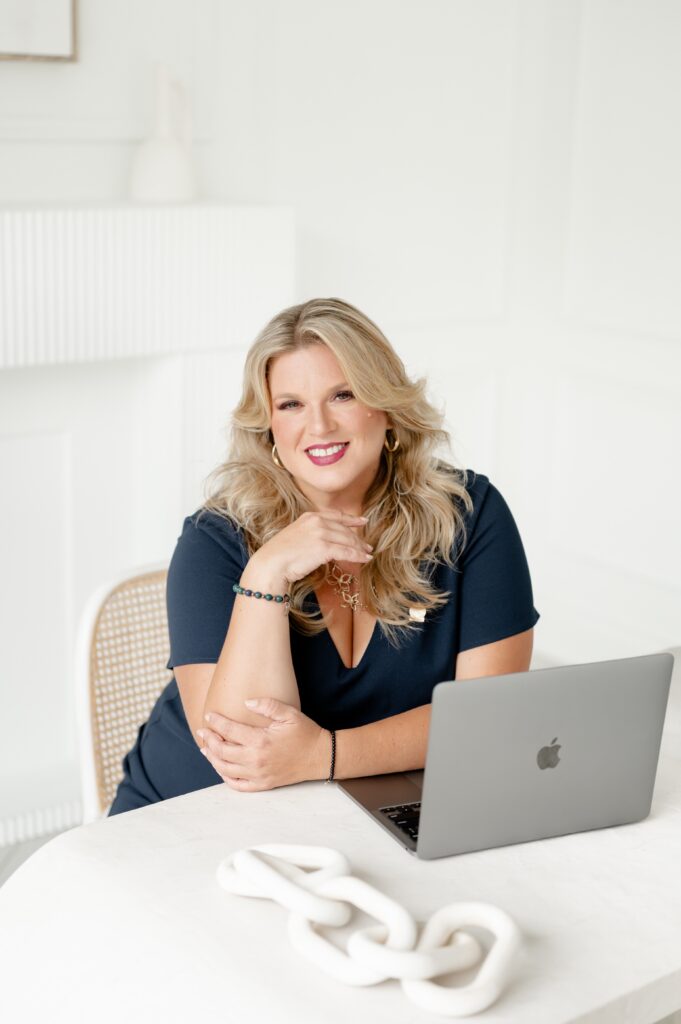 Danielle Andrews, expert wedding planner and President of WPIC, sitting at her desk.