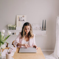 Wedding planner working at her laptop at her desk