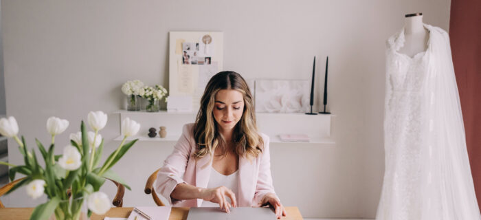 Wedding planner working at her laptop at her desk