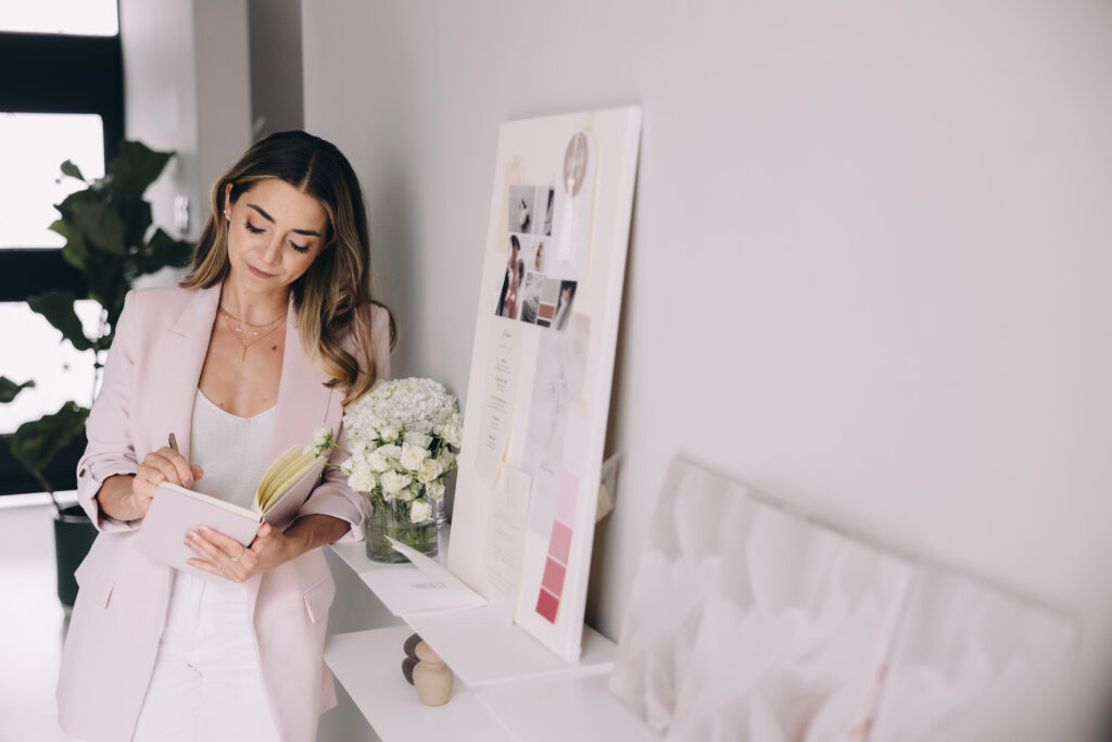 Wedding planner in her office in front of style board