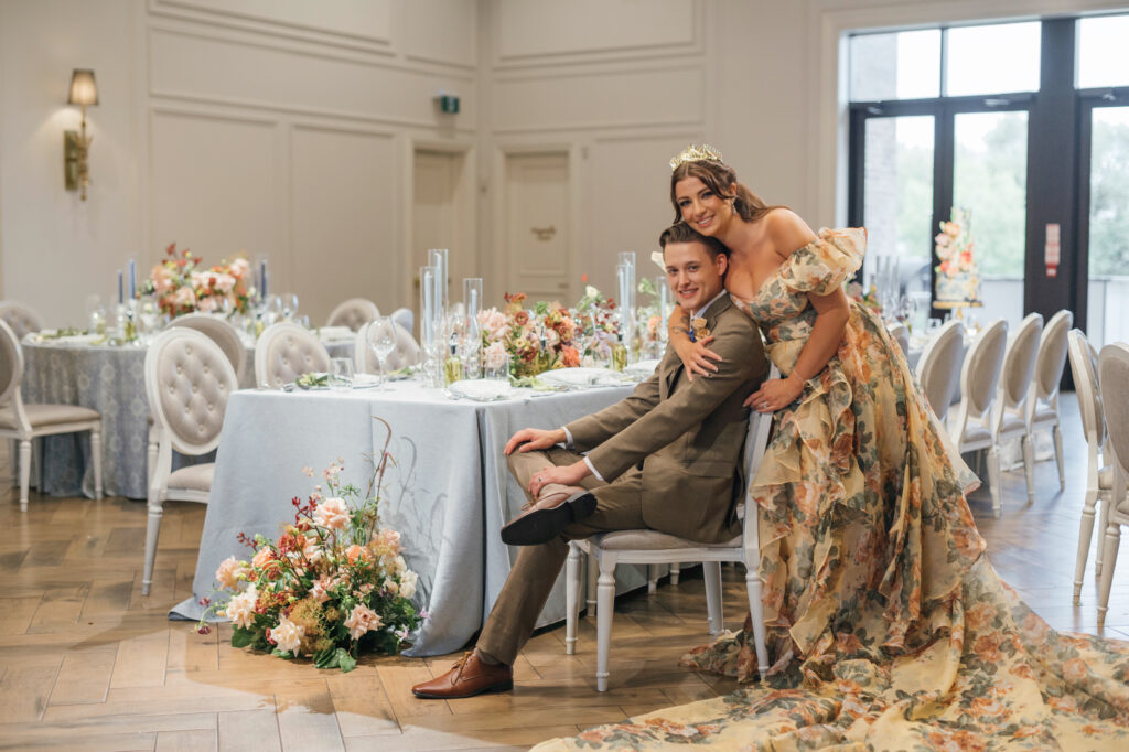 Bride in yellow wedding dress with groom in olive suit in their custom luxury reception