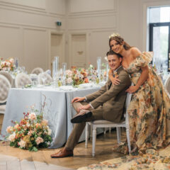 Bride in yellow wedding dress with groom in olive suit in their custom luxury reception