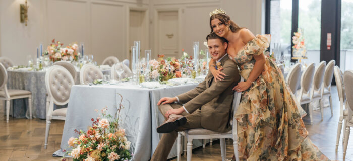 Bride in yellow wedding dress with groom in olive suit in their custom luxury reception