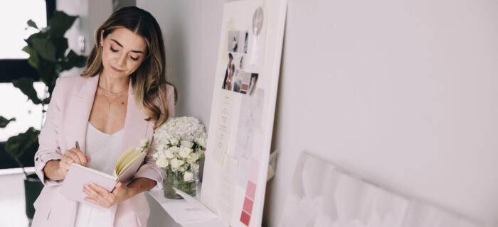 wedding planner in office looking over books