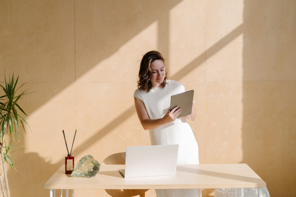 elegant wedding planner working in her office on tablet