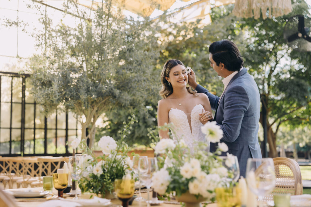 couple having a fun private moment at their wedding before the guests come in to reception