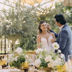 couple having a fun private moment at their wedding before the guests come in to reception