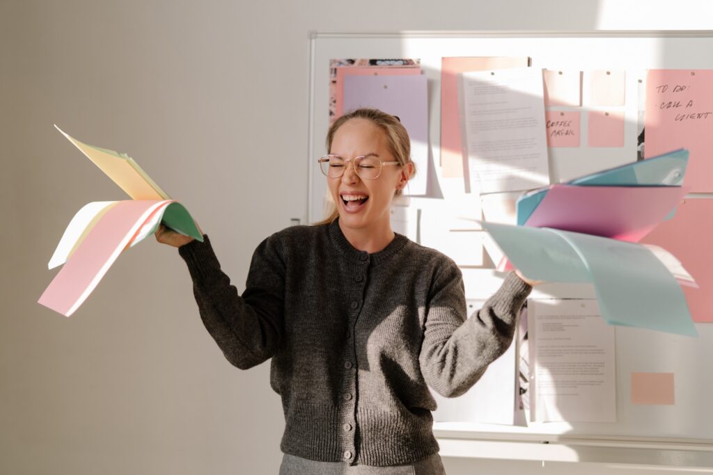wedding planner laughing in front of her to do board