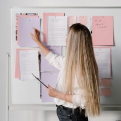 Wedding planner looking at her to do list on a white board