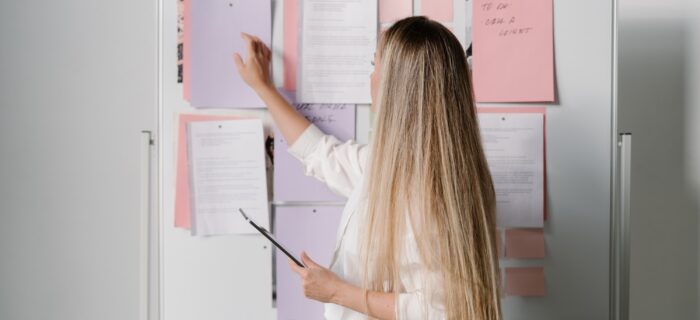 Wedding planner looking at her to do list on a white board